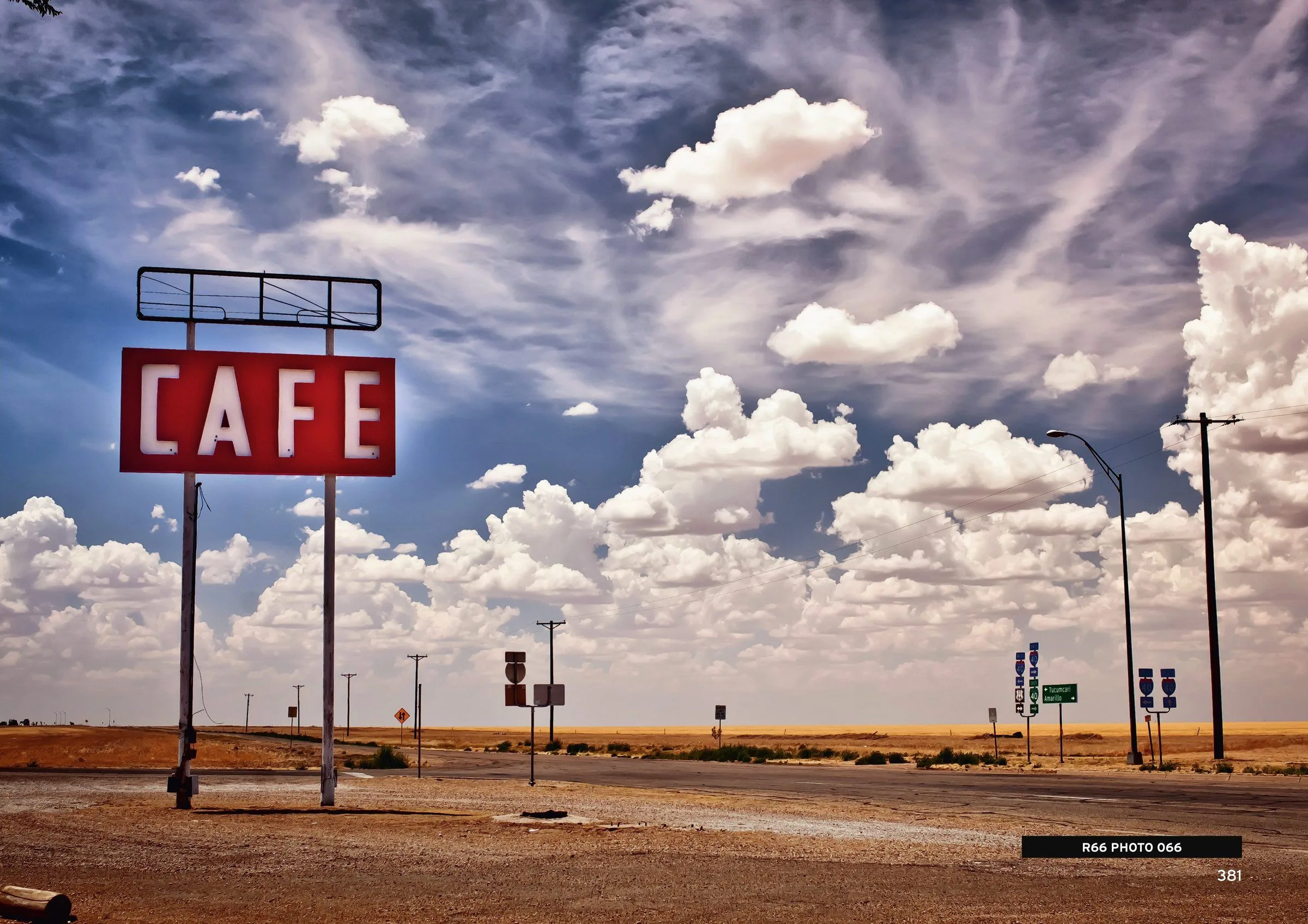 A roadside café sign under a big desert sky