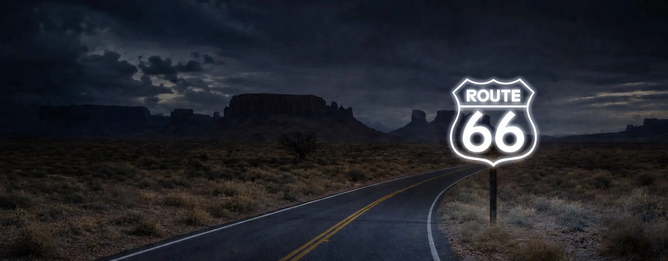 A glowing ROUTE 66 shield beside a two-lane desert highway at night